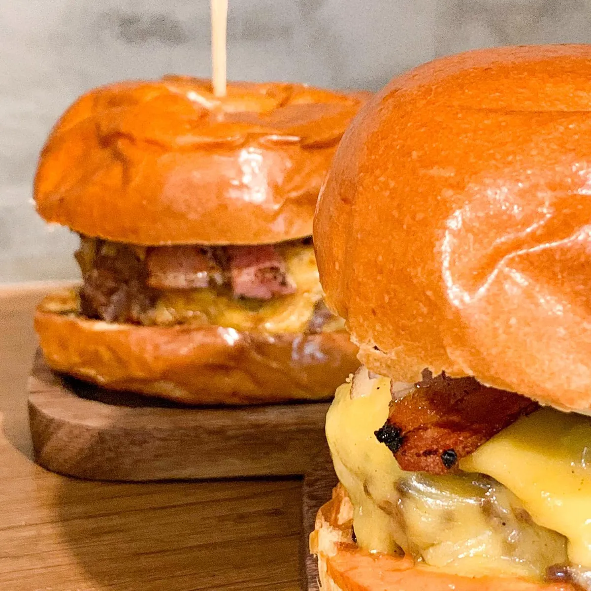 Dois hambúrgueres artesanais com queijo derretido e bacon